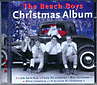 Omslag: Christmas Album med tomte i bil och några typer framför
